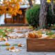 Box of autumn leaves on a stone path symbolizing grief as a natural season of life