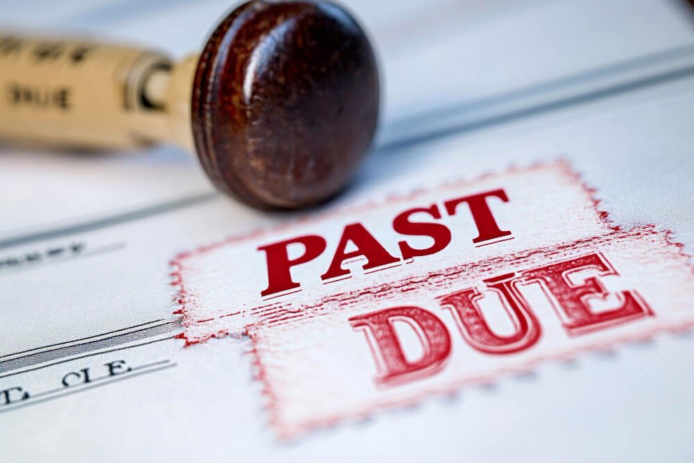 Past due bill stamped in red — the financial stress that continues while grieving.