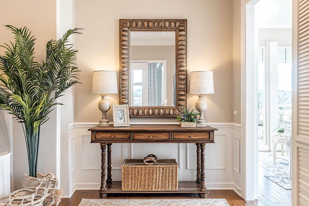 Elegant mirror and lamps on console table — symbolic of the unseen signs of grief and mourning