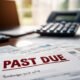 Overdue bill on desk with calculator — unpaid expenses piling up after loss.